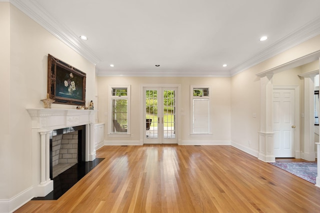 unfurnished living room with french doors, light hardwood / wood-style flooring, and crown molding