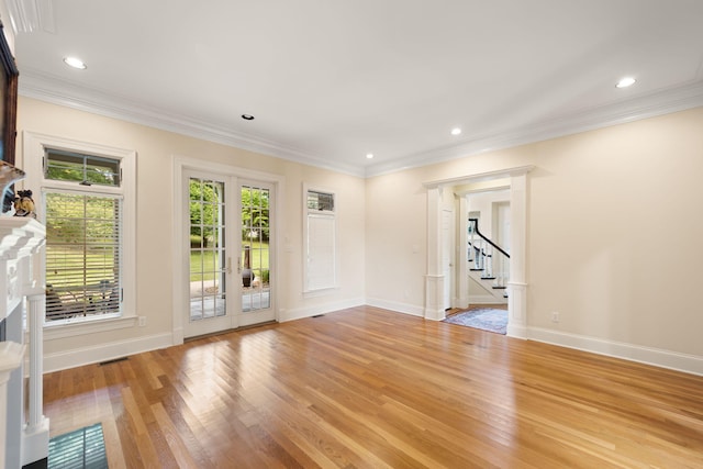 unfurnished room with a wealth of natural light, crown molding, and light hardwood / wood-style floors