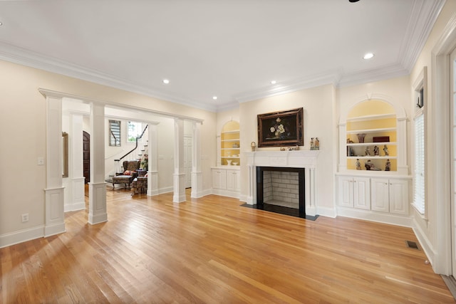 unfurnished living room with built in features, light hardwood / wood-style floors, and ornamental molding