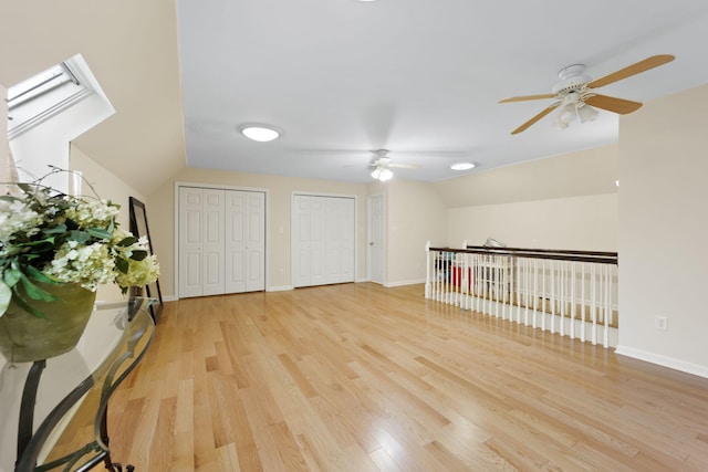 interior space with light wood-type flooring, vaulted ceiling, and ceiling fan