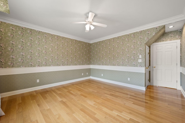 empty room featuring hardwood / wood-style flooring, ceiling fan, and ornamental molding