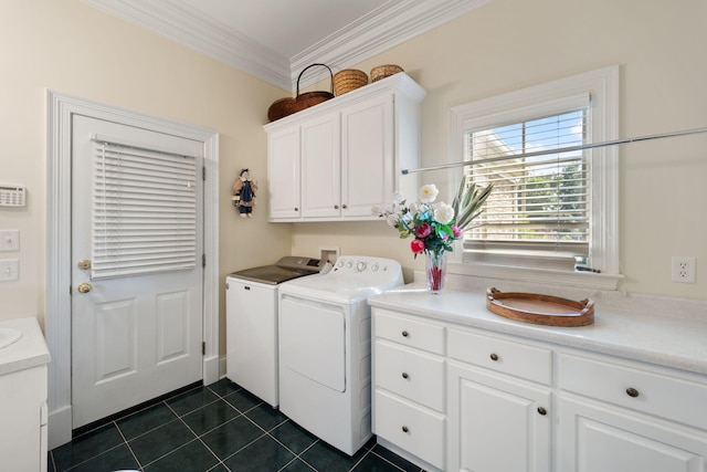 washroom featuring separate washer and dryer, cabinets, dark tile patterned flooring, and ornamental molding