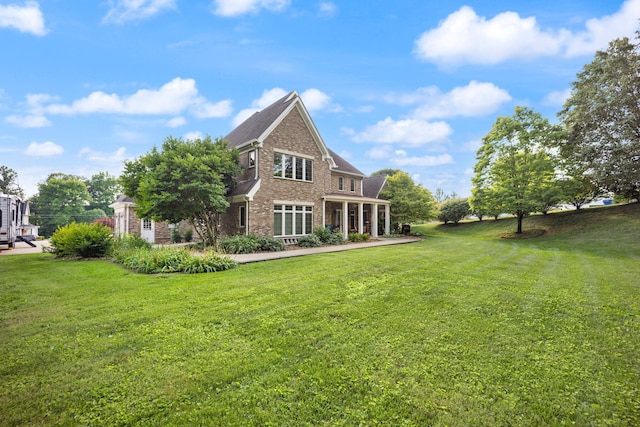 back of house with a lawn