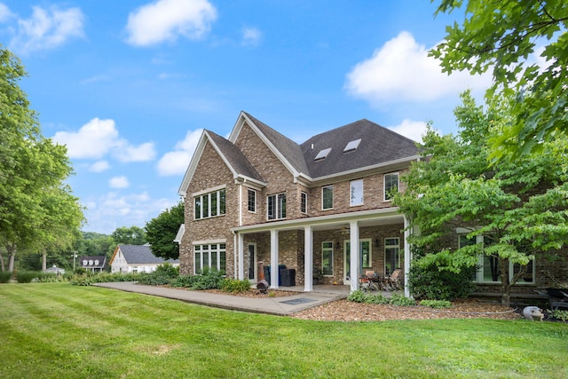 rear view of house featuring a lawn