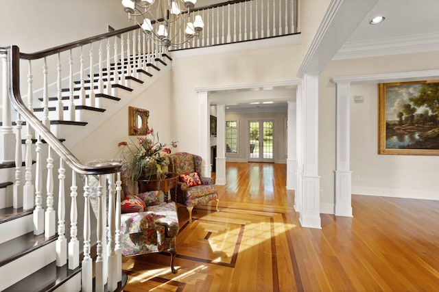 foyer featuring a chandelier, hardwood / wood-style flooring, and ornamental molding