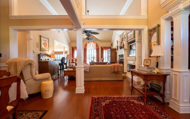 foyer featuring hardwood / wood-style flooring, ornamental molding, ceiling fan, and ornate columns