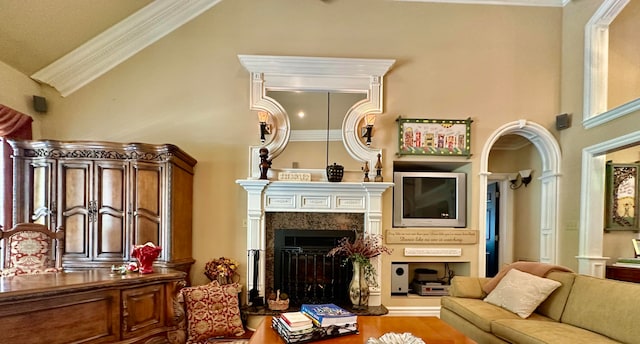 living room with crown molding, hardwood / wood-style flooring, and a towering ceiling