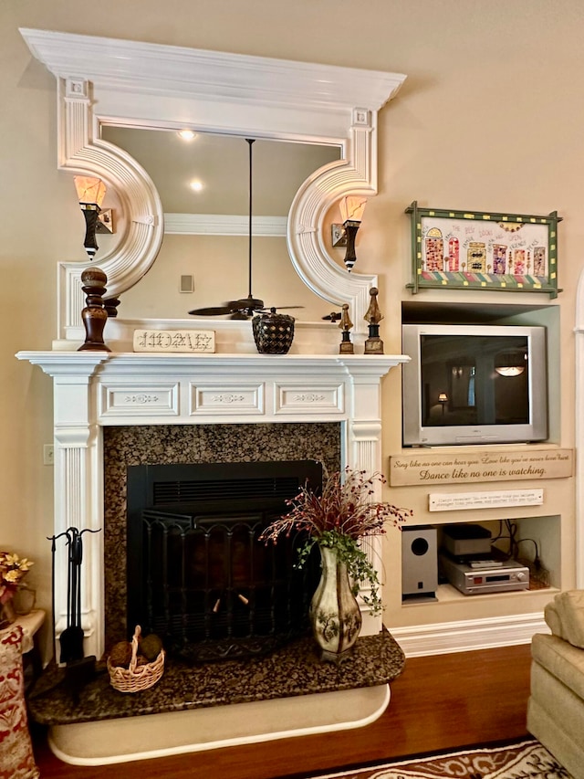 interior details with a high end fireplace and crown molding