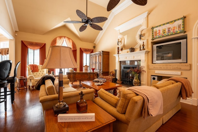 living room featuring ornamental molding, a tiled fireplace, lofted ceiling, and dark hardwood / wood-style flooring