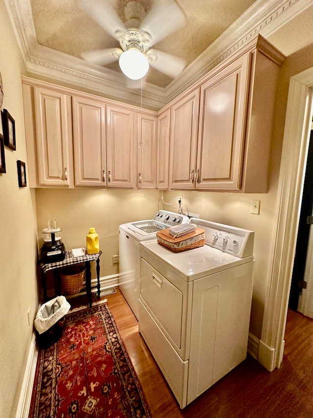 laundry area with cabinets, washer and clothes dryer, ceiling fan, hardwood / wood-style flooring, and crown molding