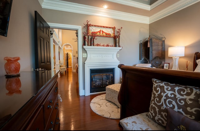 bedroom with dark hardwood / wood-style floors and crown molding