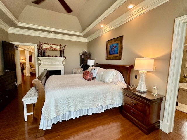 bedroom with crown molding, ceiling fan, a raised ceiling, and dark hardwood / wood-style floors