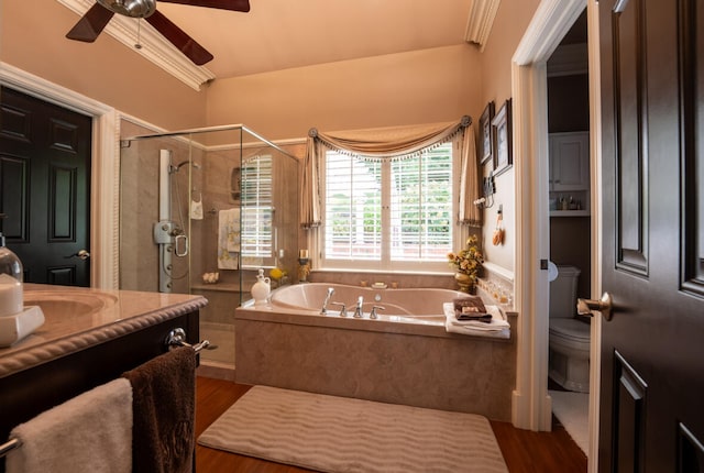 full bathroom featuring ceiling fan, shower with separate bathtub, hardwood / wood-style flooring, toilet, and vanity