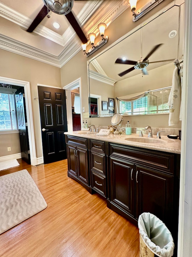 bathroom with crown molding, dual vanity, ceiling fan, and hardwood / wood-style floors