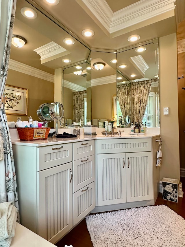 bathroom featuring crown molding, hardwood / wood-style floors, and vanity