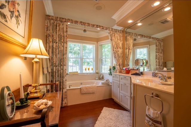 bathroom featuring a washtub, vanity, hardwood / wood-style flooring, and crown molding