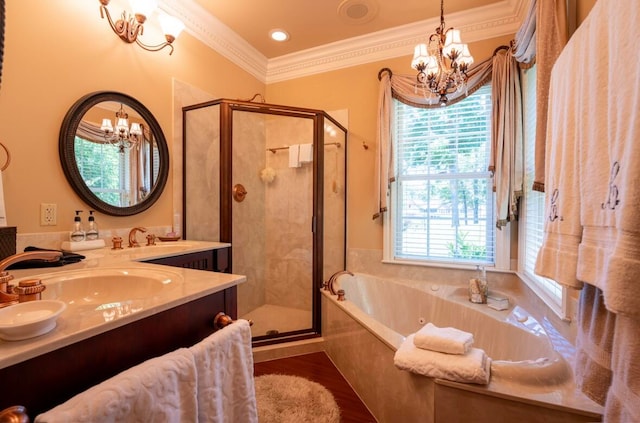 bathroom featuring an inviting chandelier, double vanity, ornamental molding, and plus walk in shower