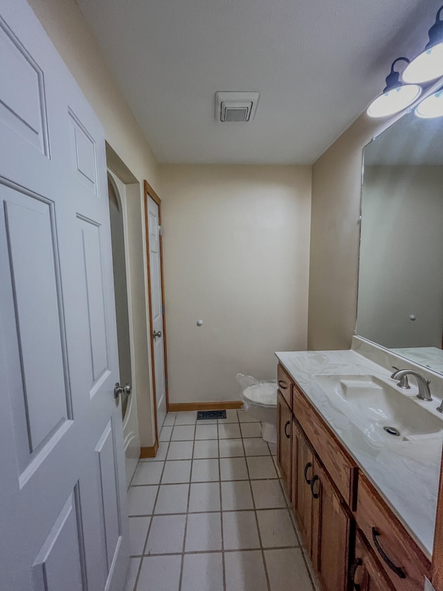 bathroom featuring vanity, toilet, and tile patterned flooring