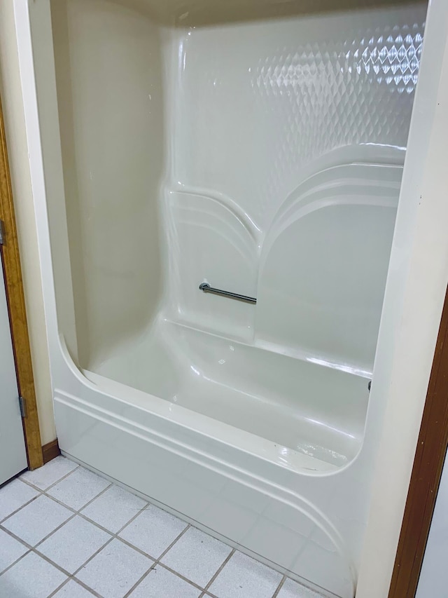 bathroom featuring a tub to relax in and tile patterned flooring