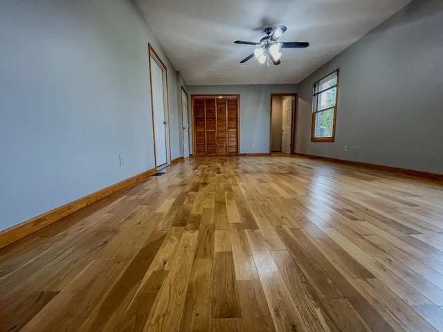 unfurnished room featuring light hardwood / wood-style flooring and ceiling fan