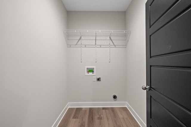 clothes washing area featuring washer hookup, hookup for an electric dryer, and hardwood / wood-style flooring