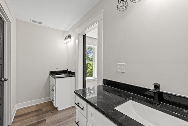 bathroom featuring hardwood / wood-style flooring and vanity