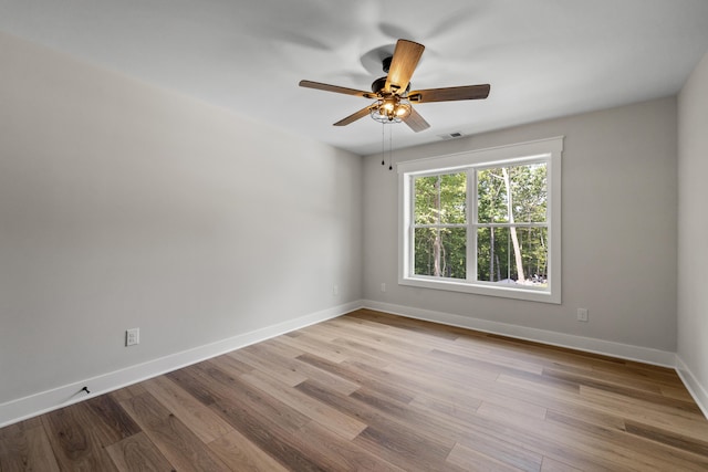 spare room featuring light wood-type flooring and ceiling fan