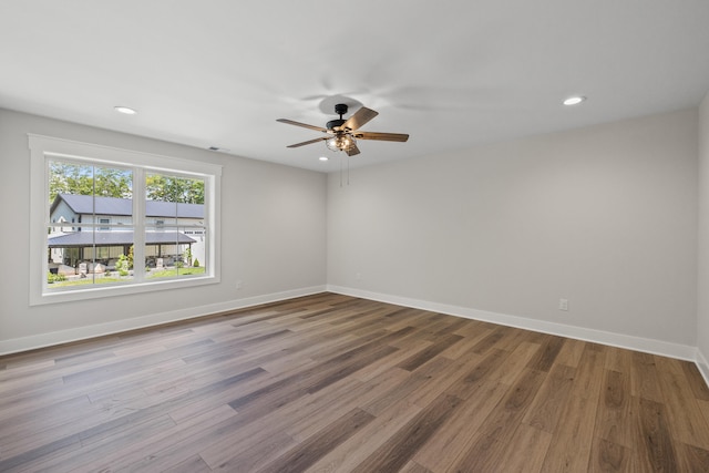 spare room with hardwood / wood-style flooring and ceiling fan