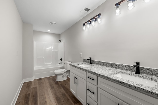 full bathroom with toilet, vanity,  shower combination, and hardwood / wood-style flooring