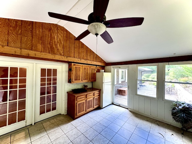 kitchen featuring white fridge, ceiling fan, light tile patterned flooring, and vaulted ceiling