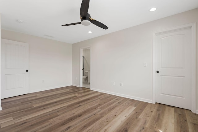 unfurnished bedroom with recessed lighting, baseboards, and wood finished floors