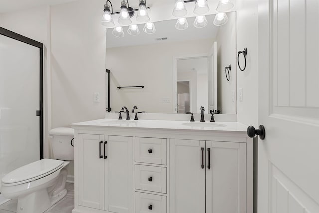 bathroom with a sink, a shower stall, and toilet