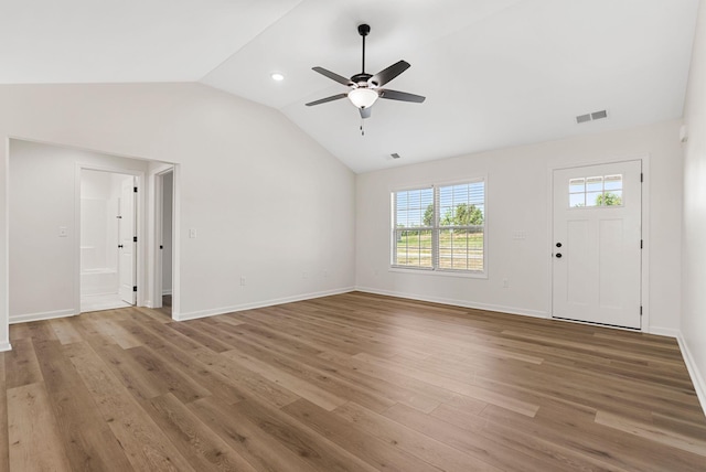 unfurnished living room featuring lofted ceiling, visible vents, light wood-style floors, ceiling fan, and baseboards