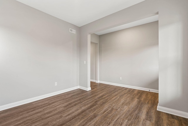 empty room featuring dark hardwood / wood-style flooring