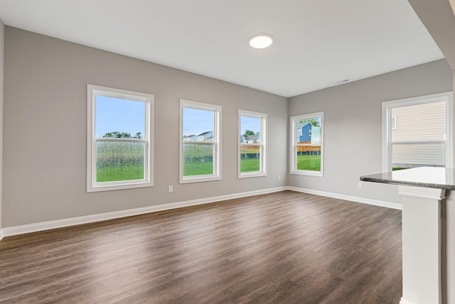 unfurnished living room featuring dark hardwood / wood-style flooring