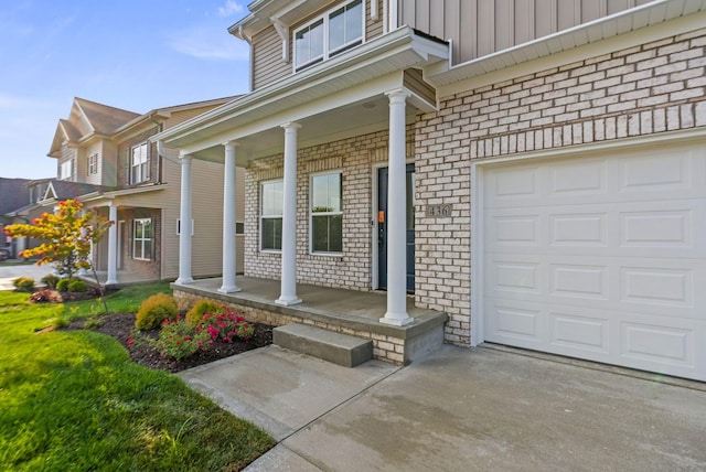 doorway to property with covered porch and a garage