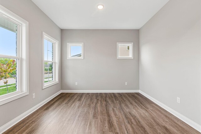 unfurnished room featuring dark hardwood / wood-style floors