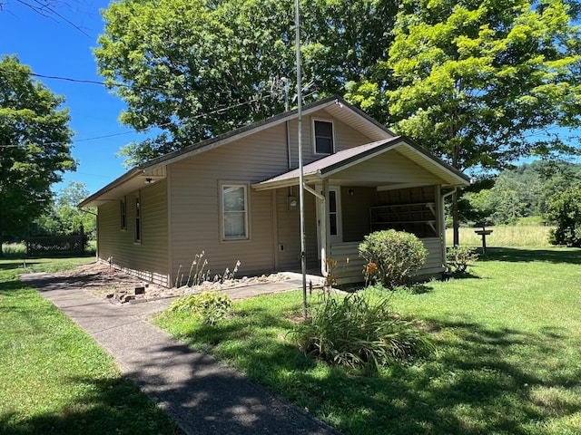 bungalow with a porch and a front yard