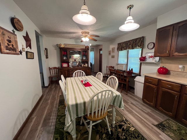 dining area with hardwood / wood-style flooring and ceiling fan