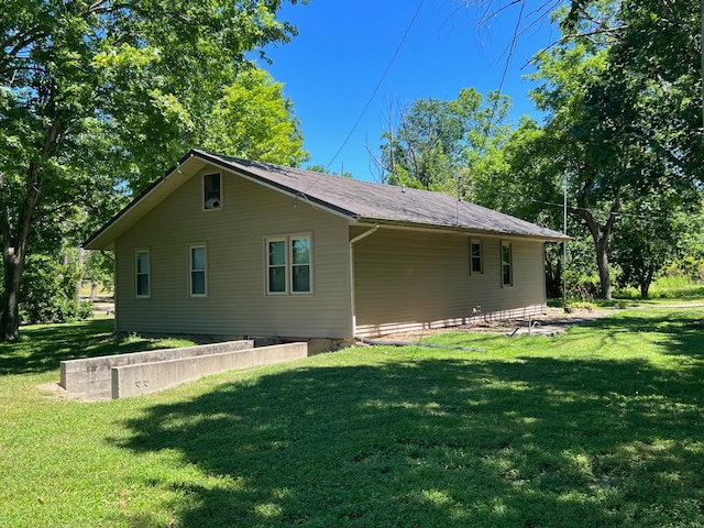 rear view of property with a yard