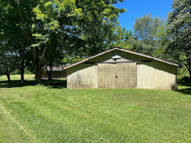 view of outdoor structure with a lawn