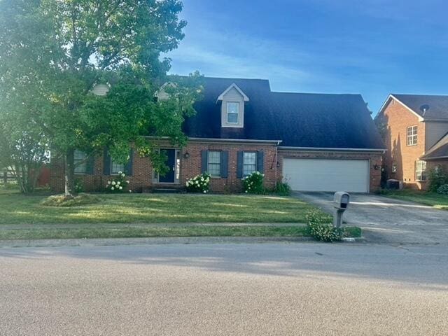 view of front of home featuring a garage and a front lawn