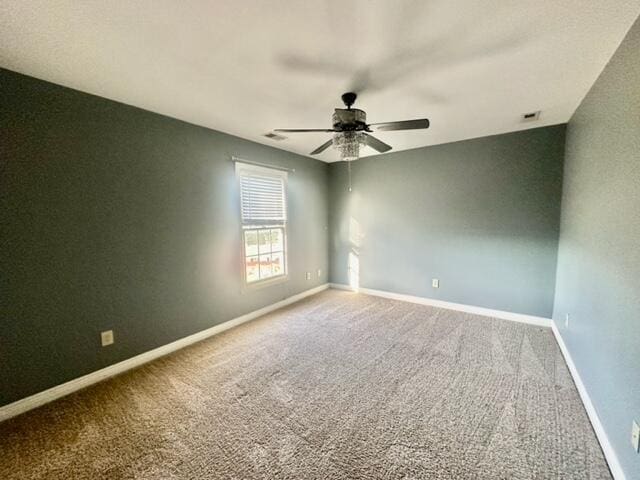 spare room featuring carpet flooring and ceiling fan