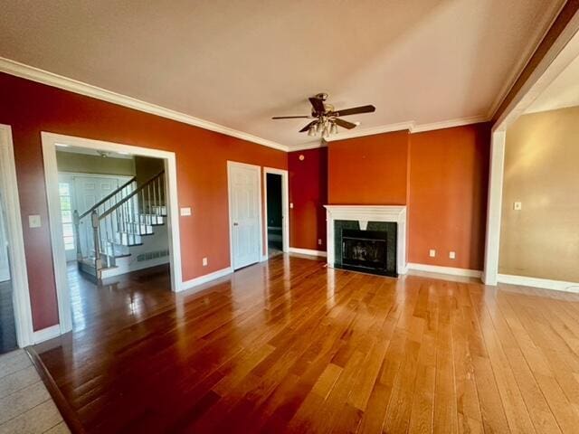 unfurnished living room with crown molding, hardwood / wood-style floors, and ceiling fan