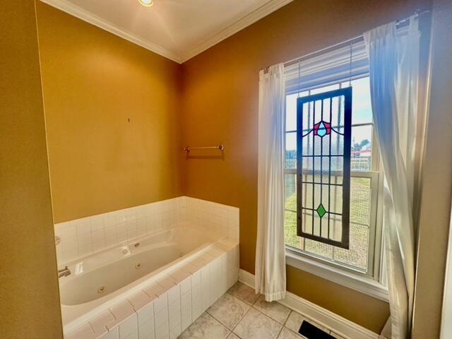 bathroom featuring tile patterned floors, tiled bath, and ornamental molding