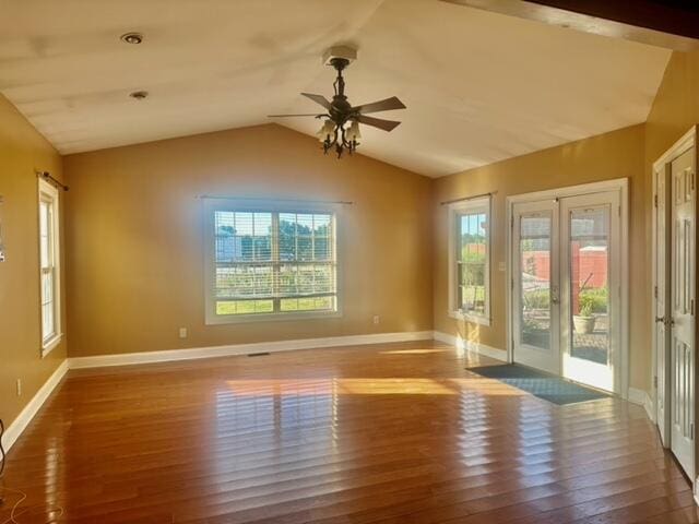 empty room with ceiling fan, dark wood-type flooring, and lofted ceiling