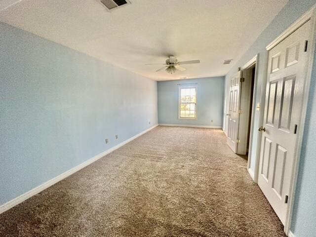 spare room featuring carpet flooring and ceiling fan