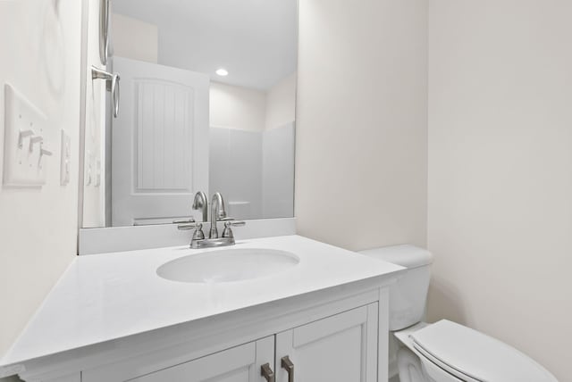 bathroom featuring vanity and toilet