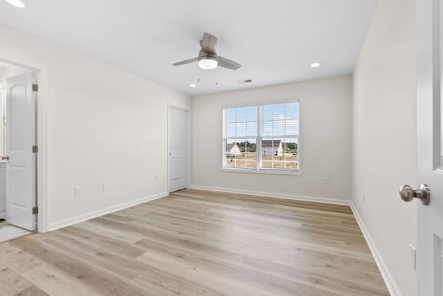 empty room with ceiling fan and light wood-type flooring