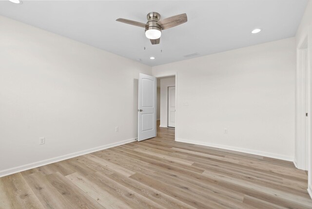 spare room featuring light hardwood / wood-style flooring and ceiling fan